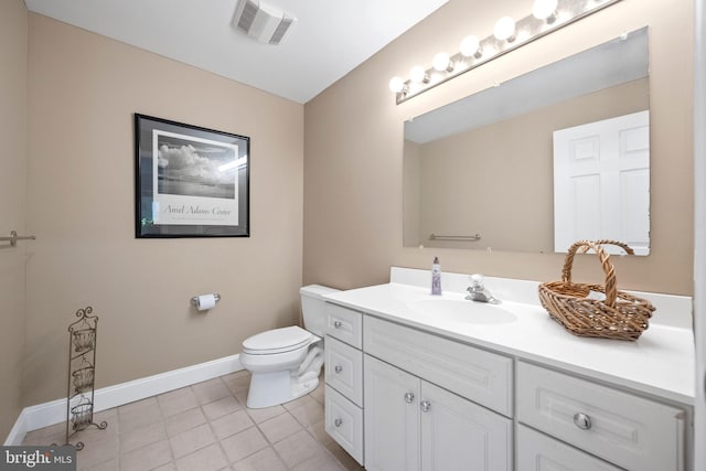 bathroom featuring vanity, toilet, and tile patterned flooring