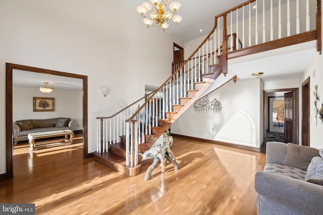 interior space featuring a high ceiling, a chandelier, and hardwood / wood-style flooring