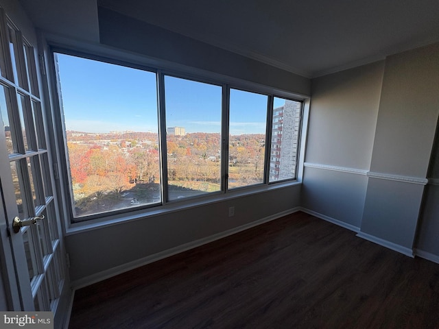 spare room with dark hardwood / wood-style flooring and ornamental molding