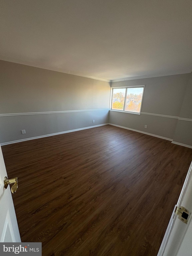 empty room with dark hardwood / wood-style floors