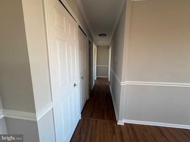 corridor with ornamental molding and dark hardwood / wood-style floors