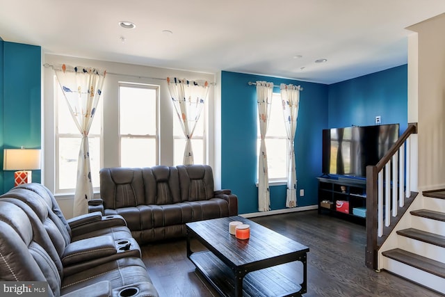 living room featuring a wealth of natural light and dark hardwood / wood-style floors