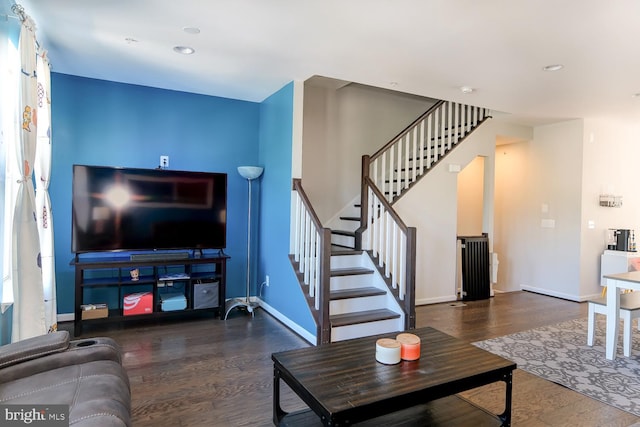 living room with dark hardwood / wood-style flooring