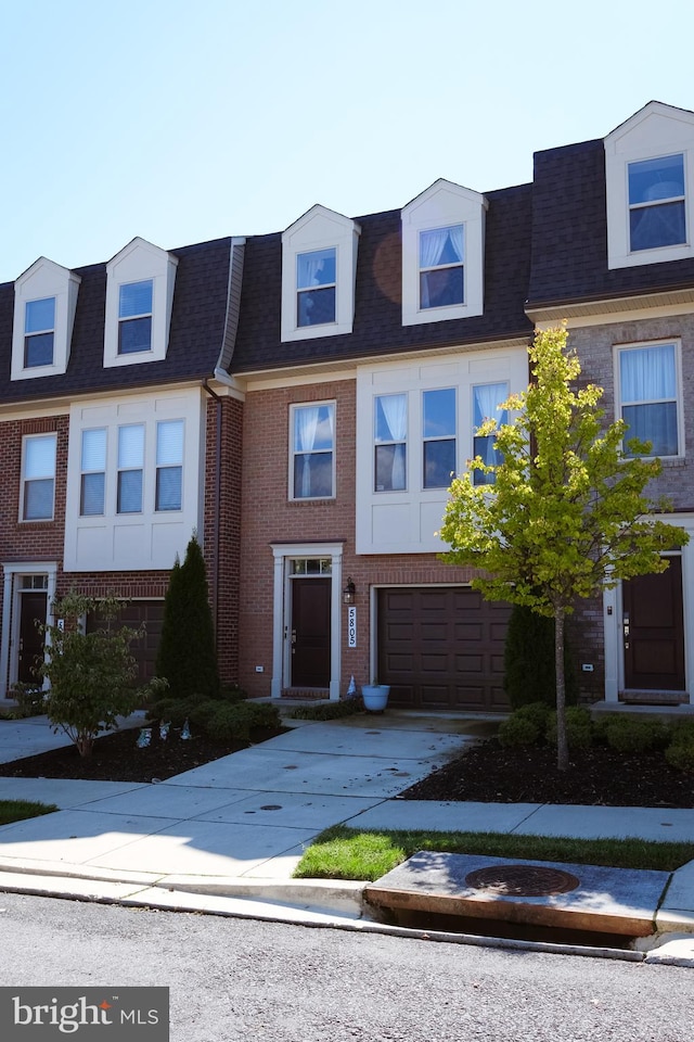 townhome / multi-family property featuring a garage