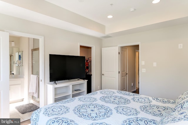 tiled bedroom featuring ensuite bathroom