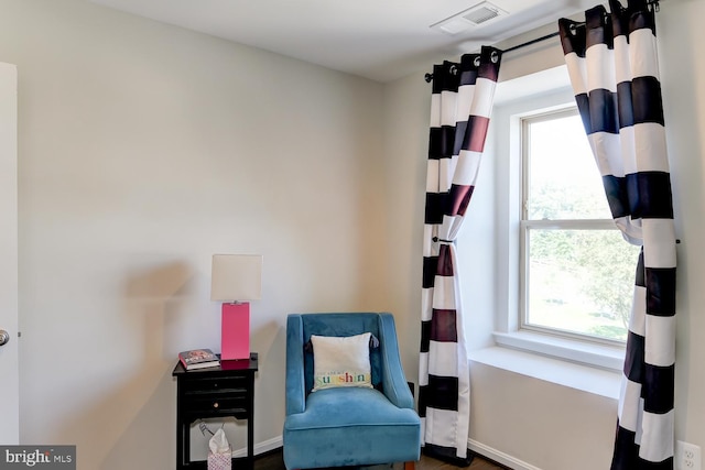 sitting room featuring a wealth of natural light and dark hardwood / wood-style flooring