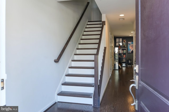 stairs featuring wood-type flooring