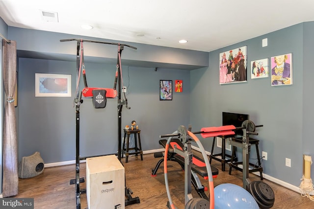 workout room with wood-type flooring