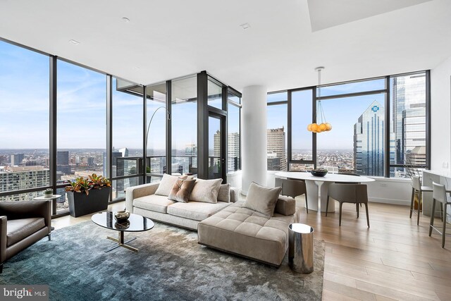 living room with expansive windows and hardwood / wood-style floors