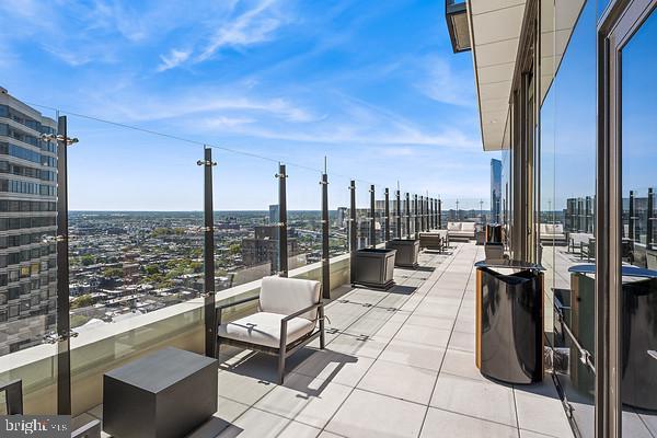 view of patio with a view of city and a balcony