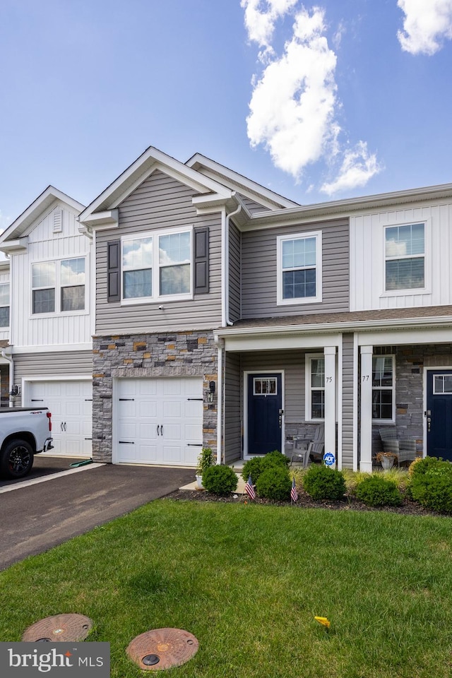 multi unit property with a front yard and a garage