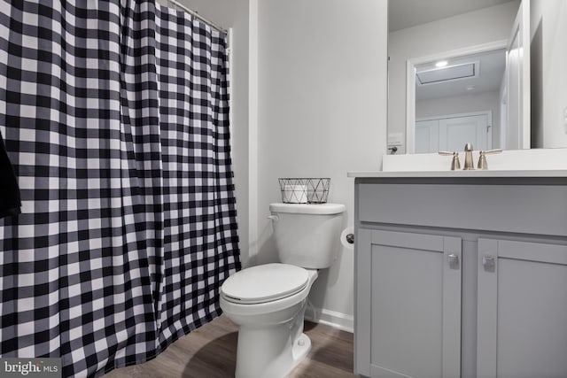 bathroom featuring toilet, vanity, and hardwood / wood-style flooring