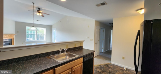 kitchen with ceiling fan, vaulted ceiling, black appliances, sink, and decorative light fixtures