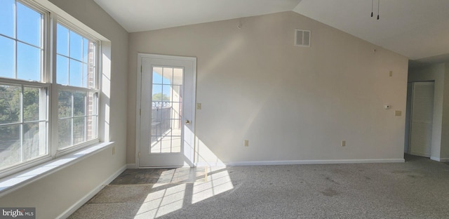 interior space with vaulted ceiling and carpet floors