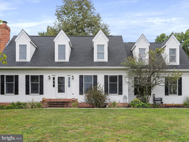 new england style home featuring a front lawn