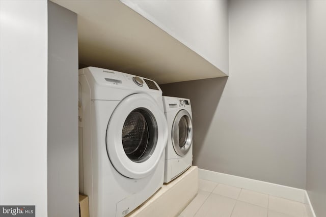 laundry room featuring independent washer and dryer and light tile patterned flooring