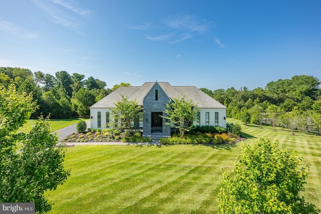 french country home featuring a front lawn