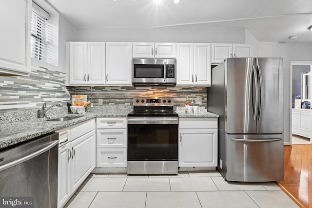 kitchen featuring white cabinets, stainless steel appliances, and sink