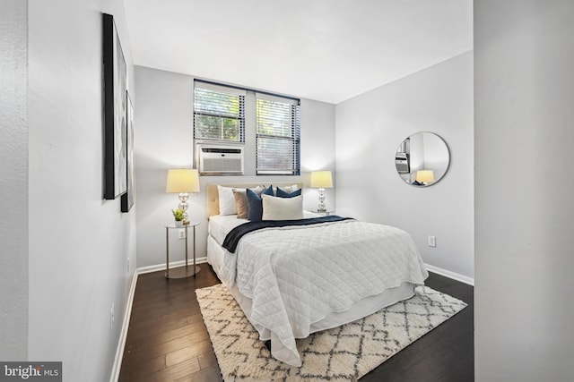 bedroom with cooling unit and dark hardwood / wood-style flooring