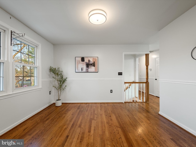 spare room with wood finished floors and baseboards