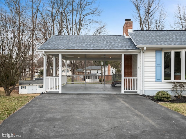 exterior space with an attached carport and driveway