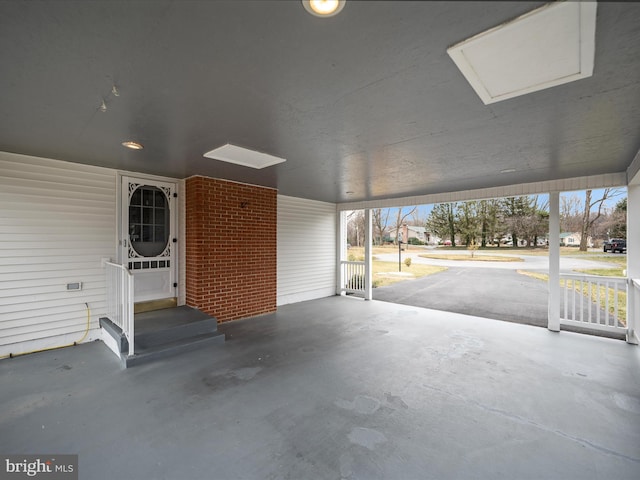 view of patio / terrace featuring entry steps and a carport