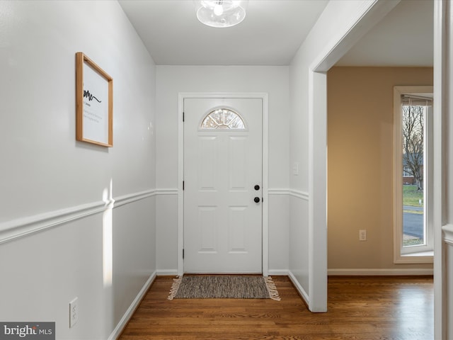 foyer entrance featuring wood finished floors and baseboards