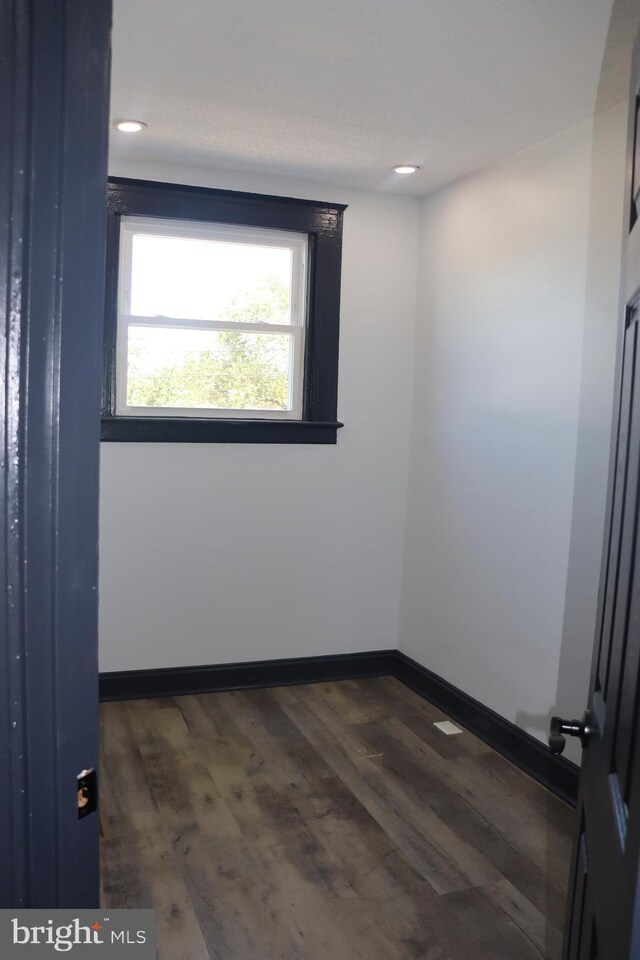 empty room featuring dark hardwood / wood-style flooring