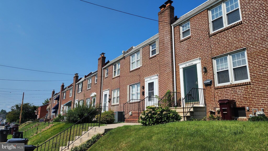 view of front facade featuring central air condition unit and a front yard