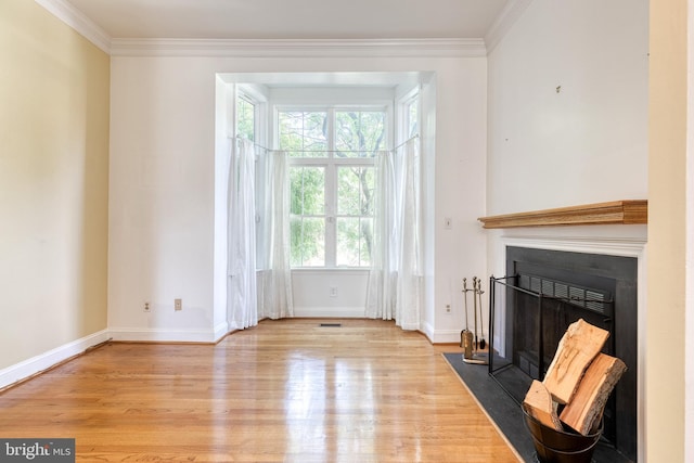 living room with light wood-type flooring and ornamental molding