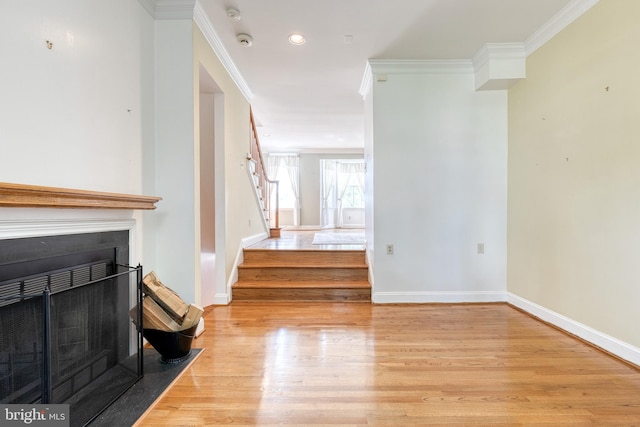 living room featuring light hardwood / wood-style flooring and crown molding