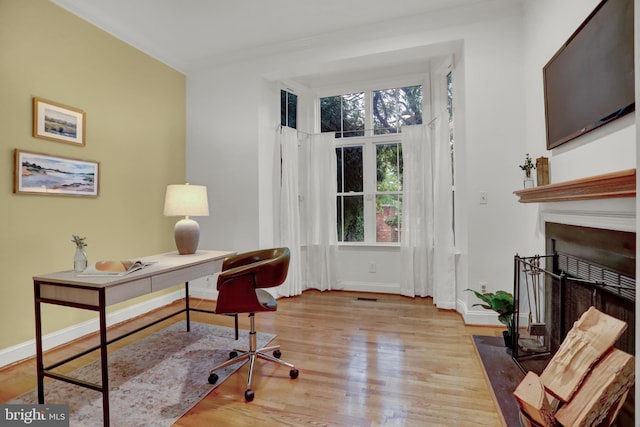 office area with light hardwood / wood-style floors