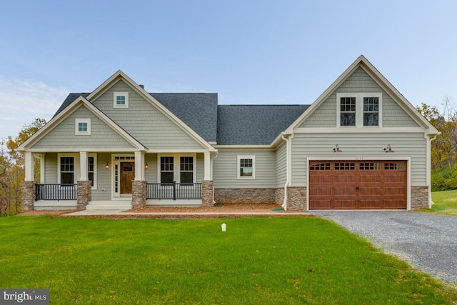 craftsman inspired home with a porch, a garage, and a front yard