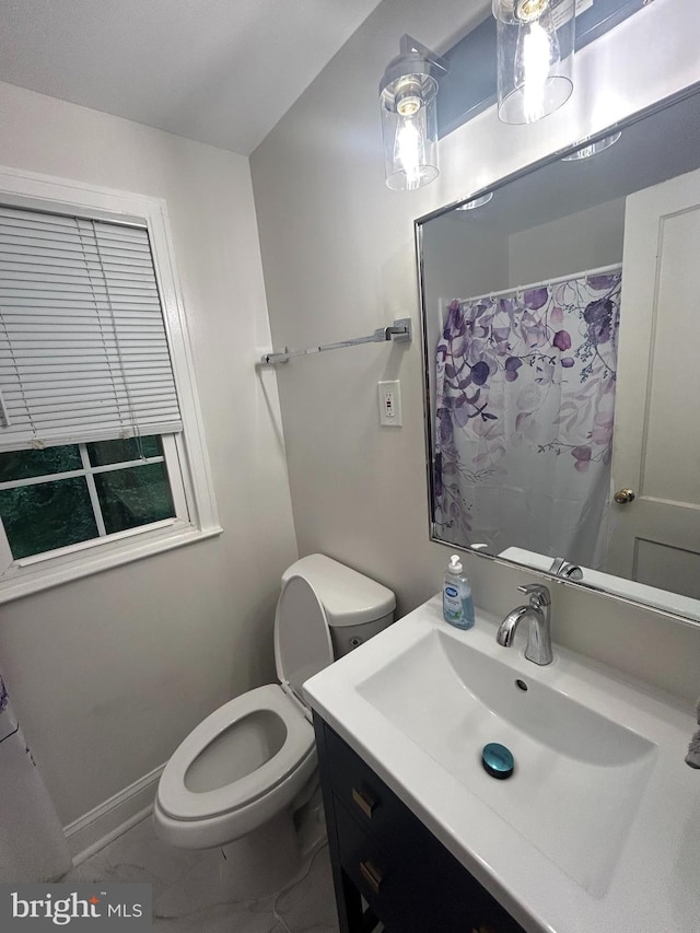 bathroom with vanity, toilet, and tile patterned flooring