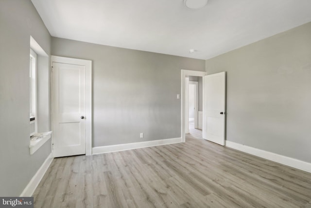 unfurnished bedroom with light wood-type flooring