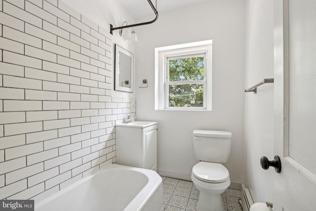 full bathroom with tiled shower / bath combo, vanity, a baseboard heating unit, toilet, and tile patterned floors