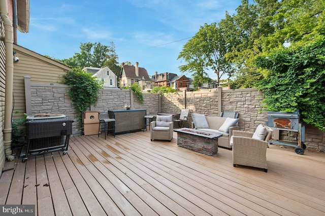 deck with central AC unit and an outdoor living space with a fire pit