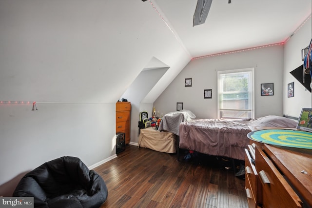 bedroom featuring dark hardwood / wood-style flooring and lofted ceiling