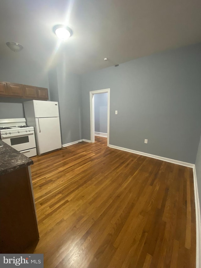 interior space with white appliances and dark wood-type flooring