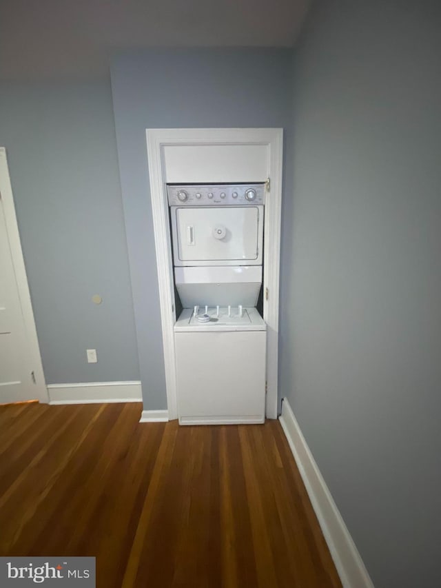 interior space featuring stacked washer / dryer and hardwood / wood-style floors