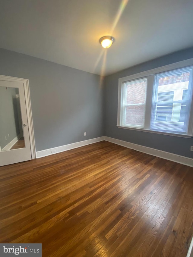 empty room featuring dark hardwood / wood-style flooring