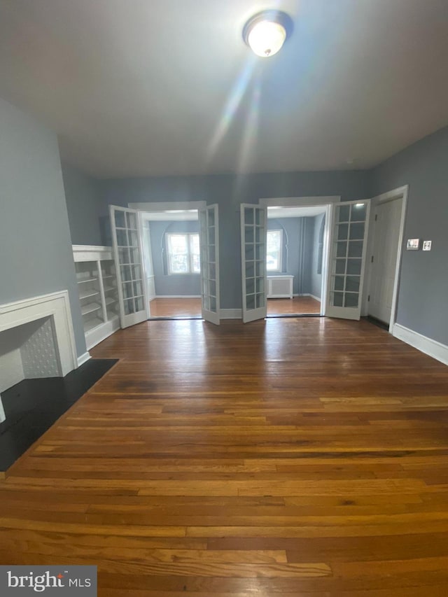 unfurnished living room with dark wood-type flooring