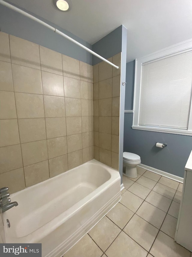 full bathroom with vanity, tiled shower / bath, tile patterned floors, and toilet