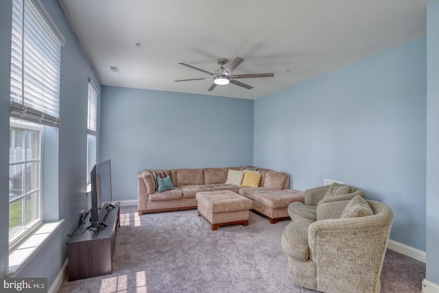 carpeted living room featuring ceiling fan