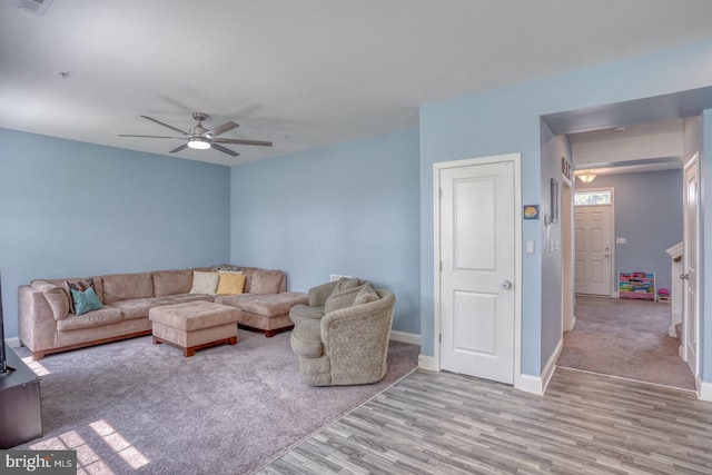 living room featuring ceiling fan and light hardwood / wood-style flooring