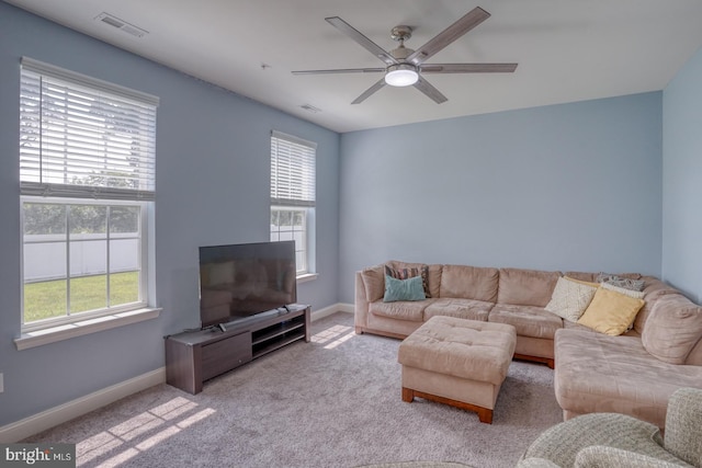 living room with ceiling fan and light colored carpet