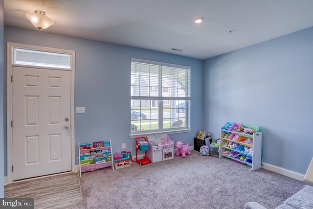 rec room with light colored carpet