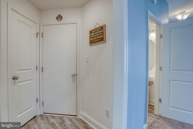 hall with light hardwood / wood-style floors