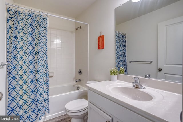 full bathroom with toilet, hardwood / wood-style flooring, shower / bath combo with shower curtain, and vanity