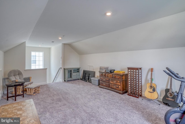 additional living space with carpet floors and vaulted ceiling